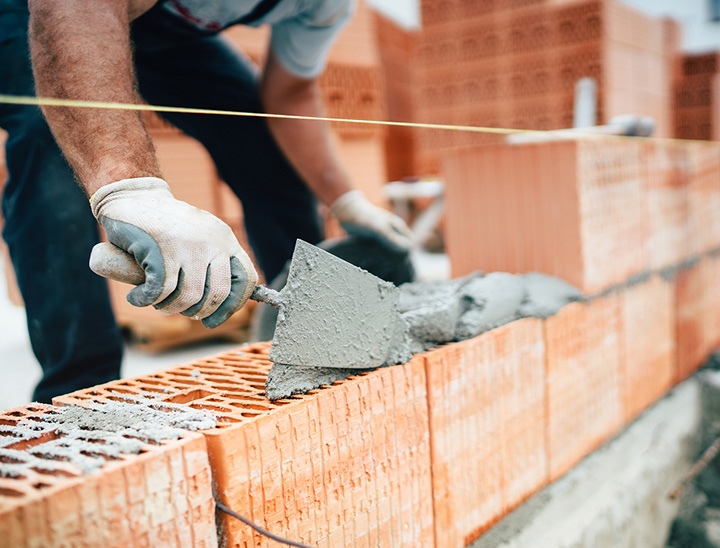 Image of person laying bricks